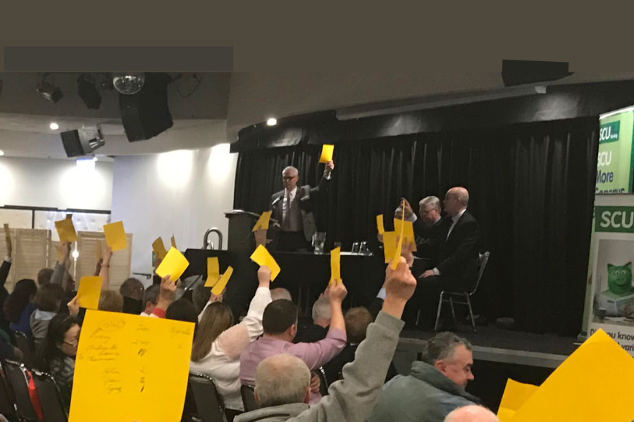 SCU members vote on the merger.